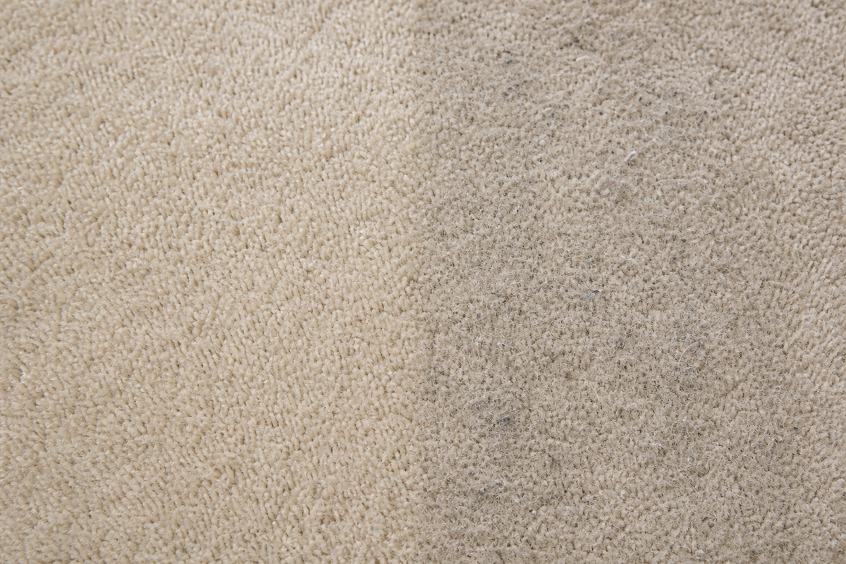 Sticky sugar residue attracting dirt after a carpet drink spill.